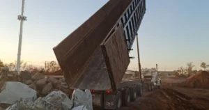 dump-truck-unloading-at-construction-site Dump truck unloading at a construction site