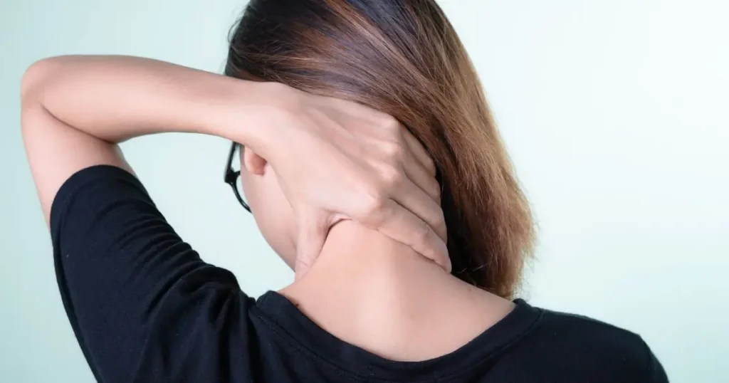 Woman holding the back of her sore neck